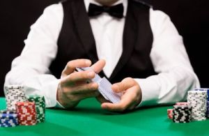 holdem dealer with playing cards and casino chips