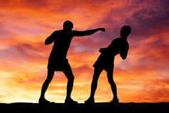 silhouettes-two-fighters-sunset-background-31912699